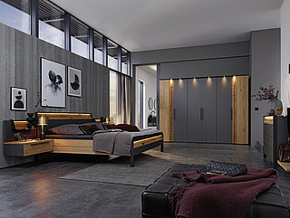  in graphite lacquer/accents in brushed solid wild oak and lacquered 1 with split wood 2 Suggestion 556001: Hinged-door wardrobe, 6-door, two storage doors with accents 1 and 2, approx. W 299, H 222, D 67 cm, studio bed with wooden headboard with accent 2 and footboard with accent 2, wooden headboard and footboard with metal elements, approx. 180 x 200 cm, two wall-mounted nightstands with accent 1, left and right, approx. W 65, H 22, D 45 cm